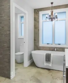 A new bathroom showing a bath, toilet and vanity