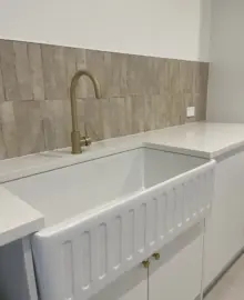 a new kitchen with curved tap over a large sink